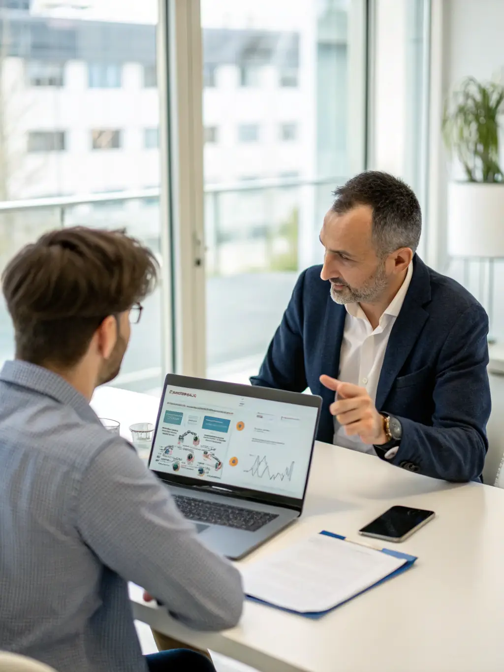 A consultant discussing digital transformation strategies with a client in a modern office setting, emphasizing collaboration and innovation.